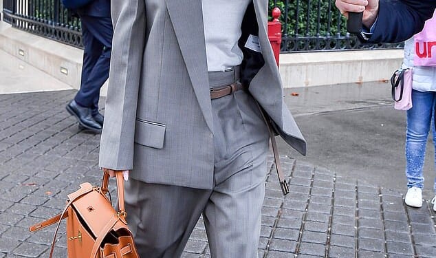 Victoria Beckham, subject of a new Netflix documentary, steps out in a grey trouser suit in Paris last week