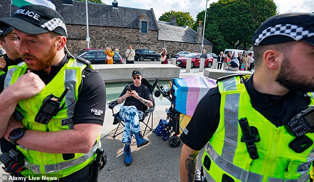 Tom Harlow flanked by Police Scotland officers