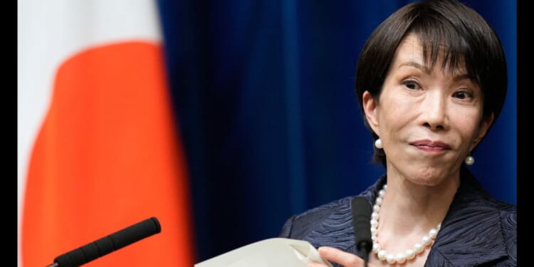 Japanese Prime Minister Sanae Takaichi listens to a journalist during a news conference in Tokyo on Oct. 21, 2025.