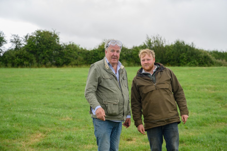 Jeremy Clarkson and Kaleb Cooper standing in a field.
