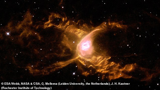 A previous image taken by the Hubble telescope shows thick orange clouds of dust forming a cross shape around the star