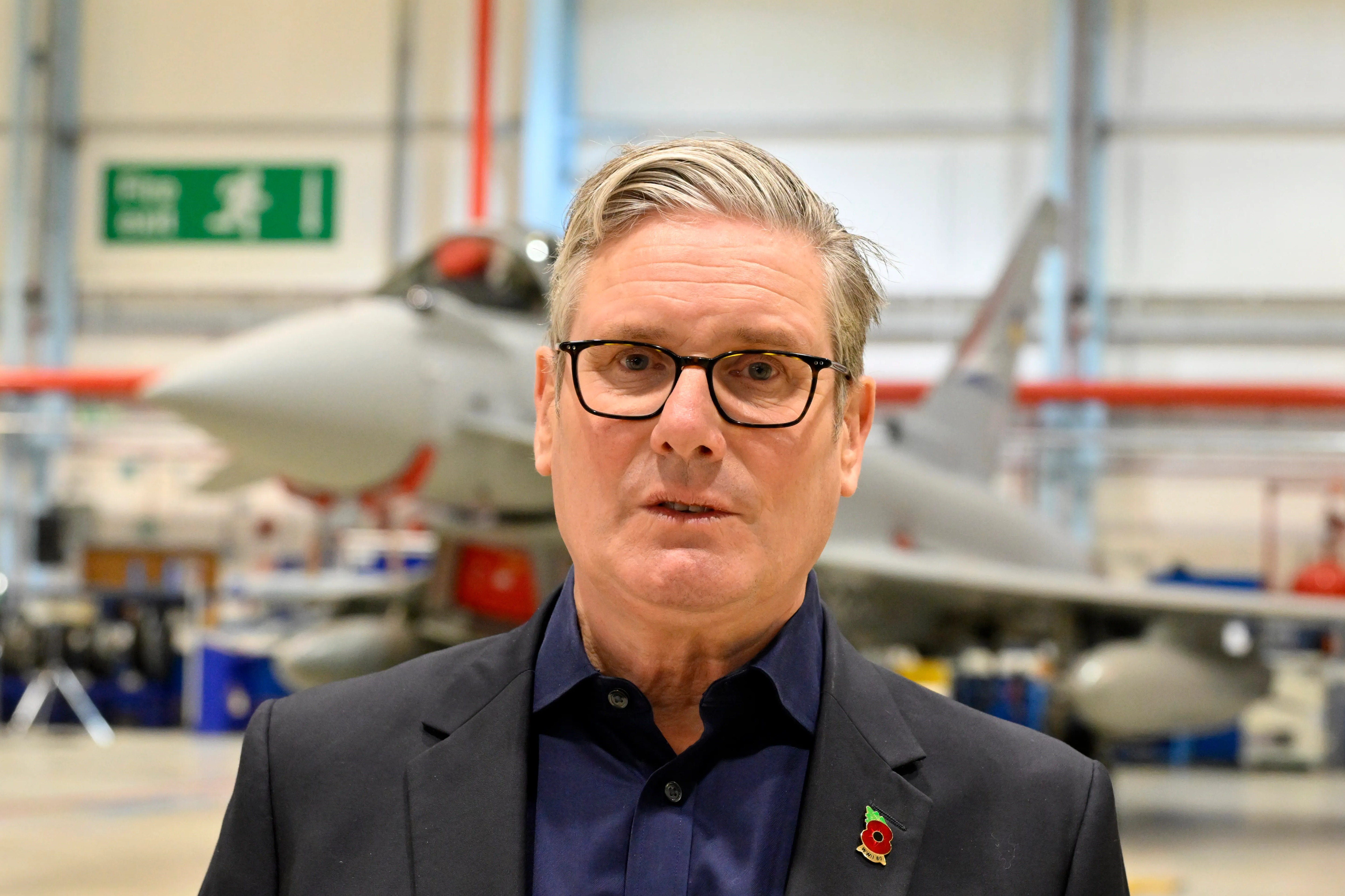 Keir Starmer at BAE Warton, with a Typhoon fighter jet in the background.