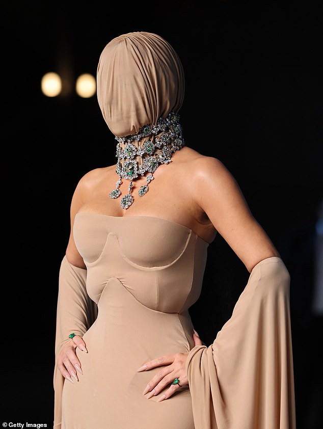 The SKIMS founder, 44, arrived to this year's Academy Museum Gala in Los Angeles with a flesh-toned mask covering her famous face