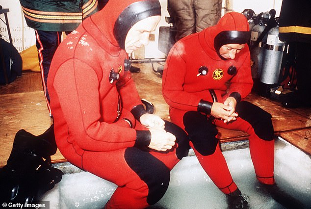 Charles, then the Prince of Wales, wears a special diving suit as he attempts to walk below the five-foot arctic ice in Canada, 1975