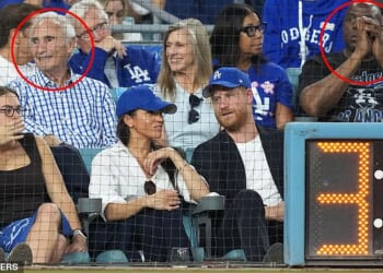 Prince Harry and Meghan Markle were sat in front of Sandy Koufax (L) and Magic Johnson (R)