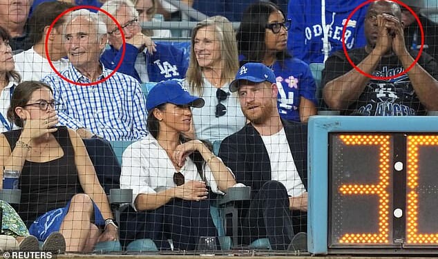 Prince Harry and Meghan Markle were sat in front of Sandy Koufax (L) and Magic Johnson (R)