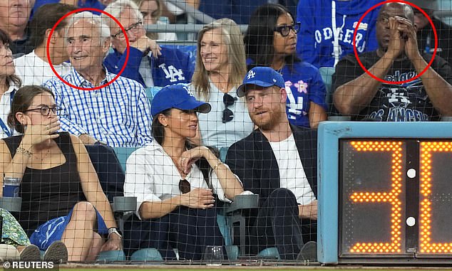 Prince Harry and Meghan Markle were sat in front of Sandy Koufax (L) and Magic Johnson (R)
