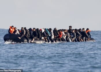 Migrants cross the Channel by small boat - heading for Britain - at the end of last month