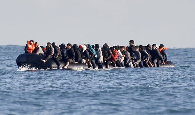 Migrants cross the Channel by small boat - heading for Britain - at the end of last month