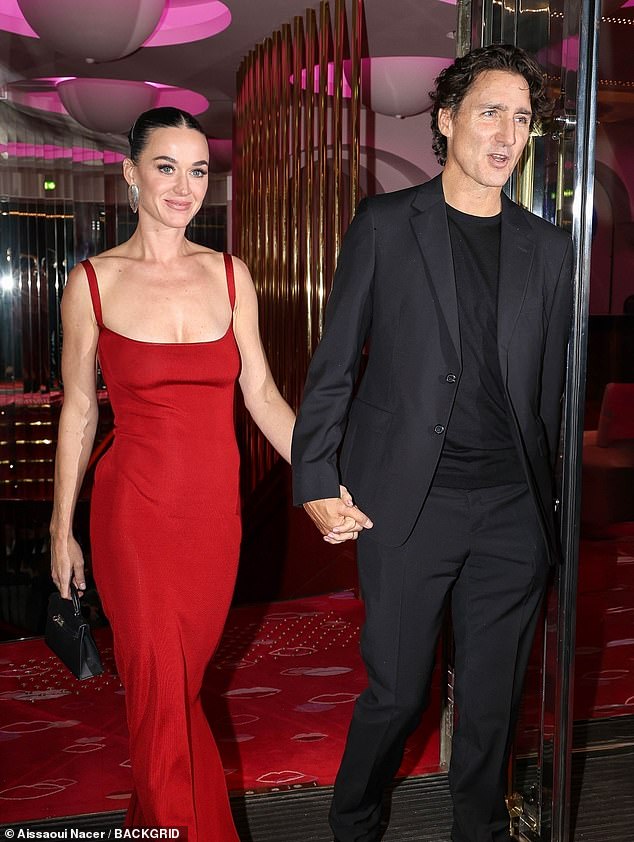 Styling her dark tresses in a neat up do, Katy accessorised with a pair of chunky silver drop earrings