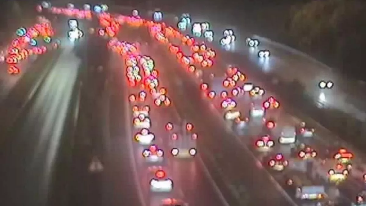 Overhead view of a highway at night, showing traffic with red taillights and white headlights.