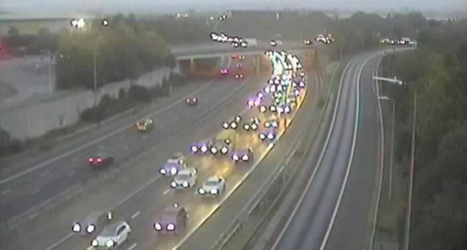 Overhead view of congested M60 motorway with cars and an overpass.