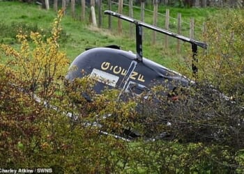 The helicopter landed on its side in a field near an industrial estate in Bentley shortly after 10am