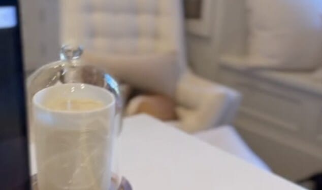 Ahead of the launch on Tuesday afternoon, the Duchess of Sussex, 44, shared a clip of her working at her laptop and perched on her desk was one of her new $64 candles and a blue notebook with her royal cypher embossed in gold on the cover (pictured right)