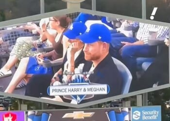 Prince Harry and Meghan appeared to be booed as they featured on the big screen perched on front row seats