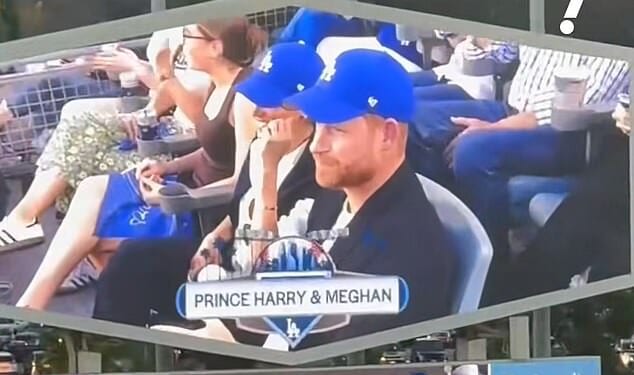 Prince Harry and Meghan appeared to be booed as they featured on the big screen perched on front row seats