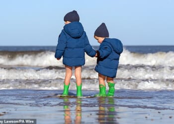 Two boys play in the sea on a cold day in Scarborough during October half-term last year