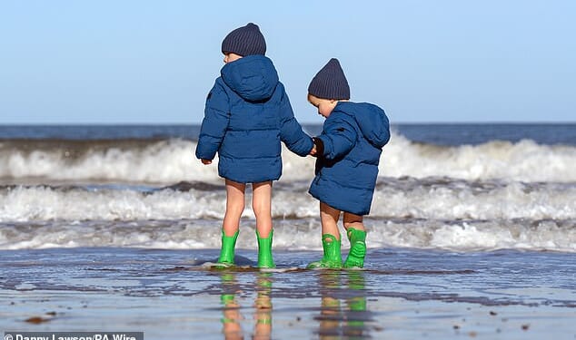 Two boys play in the sea on a cold day in Scarborough during October half-term last year