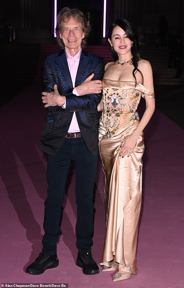 The Paint It Black hitmaker looked dapper in a dark suit alongside fiancée Melanie, 38, stunned a gold floral gown