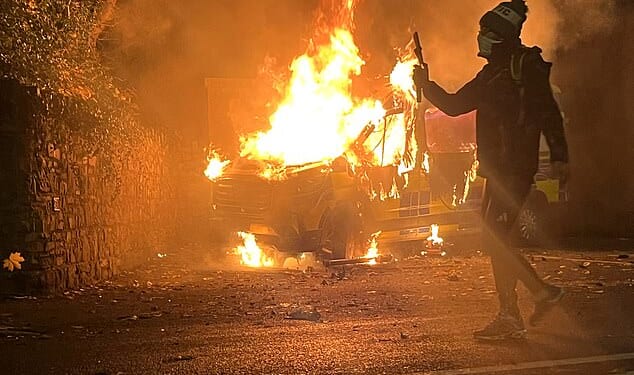 A migrant who allegedly sexually assaulted a 10-year-old girl outside an asylum seeker hotel in Dublin was awaiting deportation (pictured: Riots on Tuesday night)