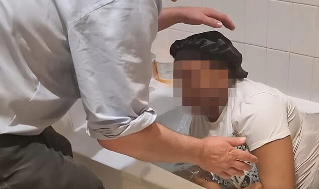 An image in a now-deleted social media post appears to show a female asylum seeker being converted to Christianity in a bath