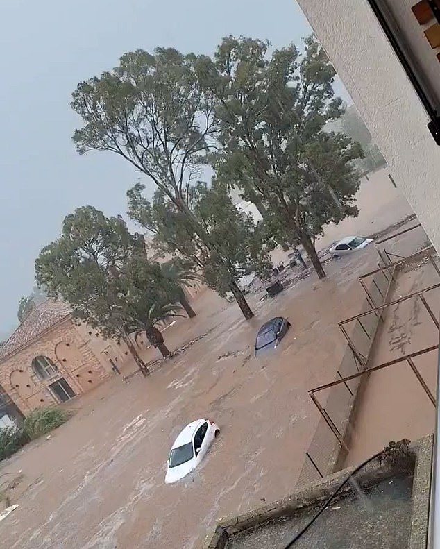 Cars can be seen almost submerged by the water following from the torrential downpour