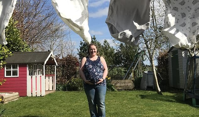 Jacqui Hunter pictured at home among the baby–gros picked out for Olivia before tragedy struck. She died giving birth to Olivia stillborn