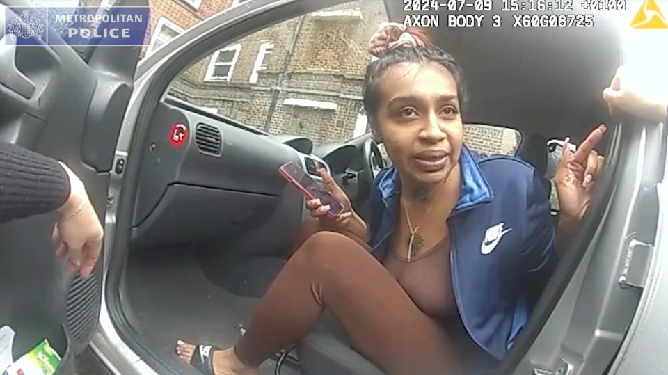 Nazli Merthoca, 24, sitting in a car and holding a phone, captured from police bodycam footage.
