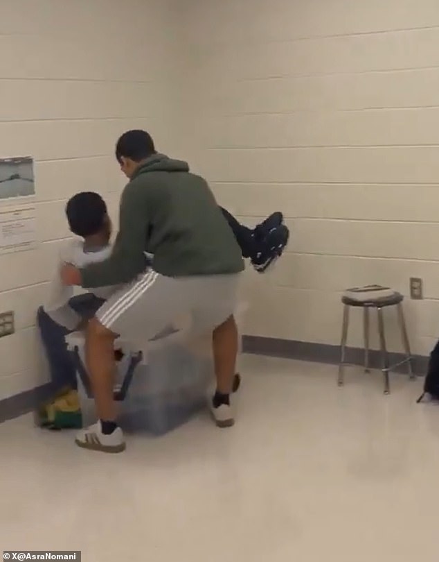 The two 'abducted' students were swiftly dragged behind the curtain with their faces covered for the remainder of the skit (pictured)