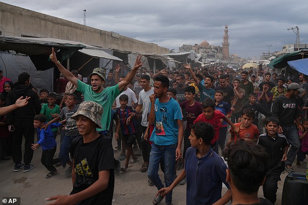 Palestinians celebrate following the announcement that Israel and Hamas have agreed to the first phase of a peace plan to pause the fighting, in Khan Younis, southern Gaza Strip, Thursday, October 9, 2025