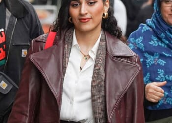 An NHS junior doctor who vowed she 'would never condemn' the October 7 Hamas attacks has today arrived at her tribunal wearing a necklace with a distinctive gold charm showing the number 'seven'