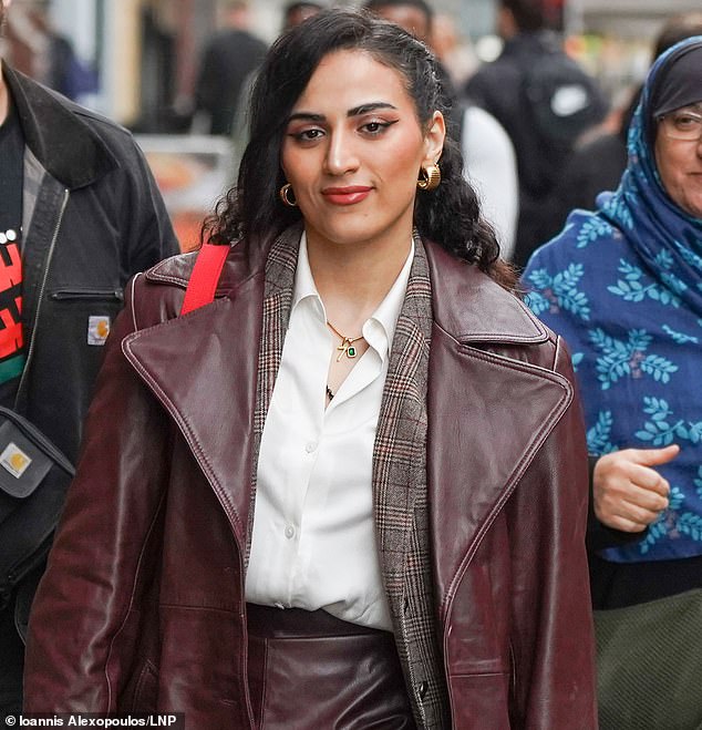 An NHS junior doctor who vowed she 'would never condemn' the October 7 Hamas attacks has today arrived at her tribunal wearing a necklace with a distinctive gold charm showing the number 'seven'
