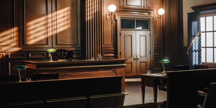 This stock image shows an empty courtroom.