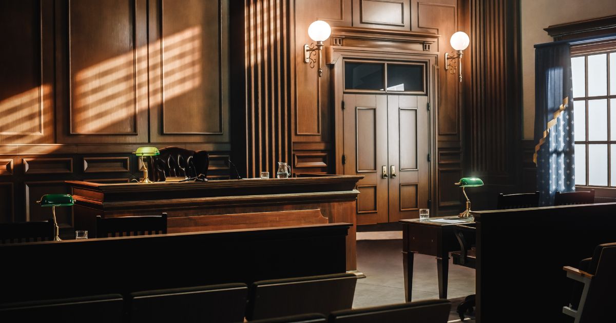 This stock image shows an empty courtroom.