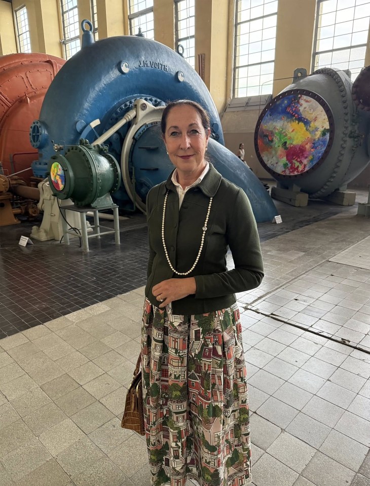 Iris Stalzer standing in front of large industrial equipment.