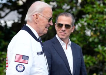 Then-President Joe Biden, left, and Hunter Biden. right, walk toward Marine One on the South Lawn of the White House in Washington, D.C., on July 26, 2024.