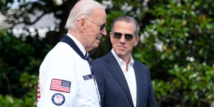 Then-President Joe Biden, left, and Hunter Biden. right, walk toward Marine One on the South Lawn of the White House in Washington, D.C., on July 26, 2024.