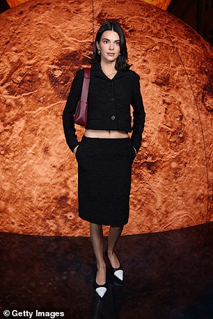 Model Kendall Jenner, 29, also flaunted her toned midriff in a cropped black jacket and skirt and boosted her height with heels