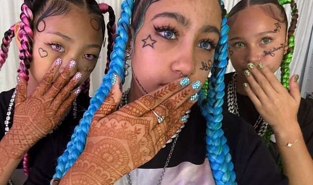 Kim Kardashian's daughter North West has debuted a shocking new look that included fake face tattoos, piercings and grillz