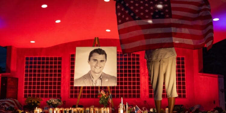 People pay their respects during a candlelight vigil for Charlie Kirk at a makeshift memorial at Orem City Center Park in Orem, Utah, on Sept. 11.