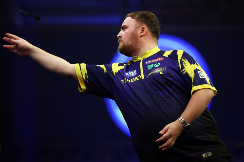 Luke Littler of England throwing a dart during a match.