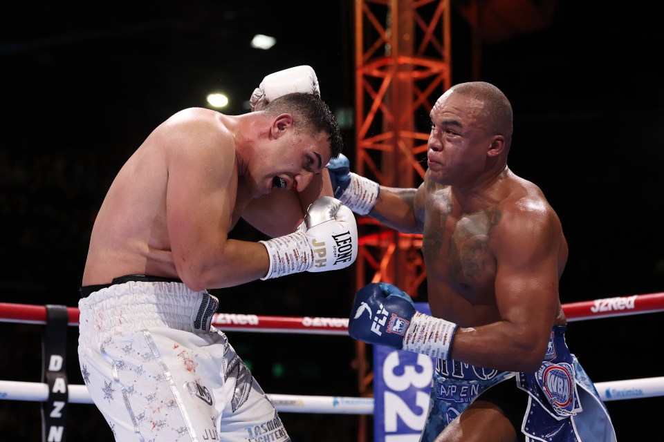 Fabio Wardley punches Justis Huni during their heavyweight fight.