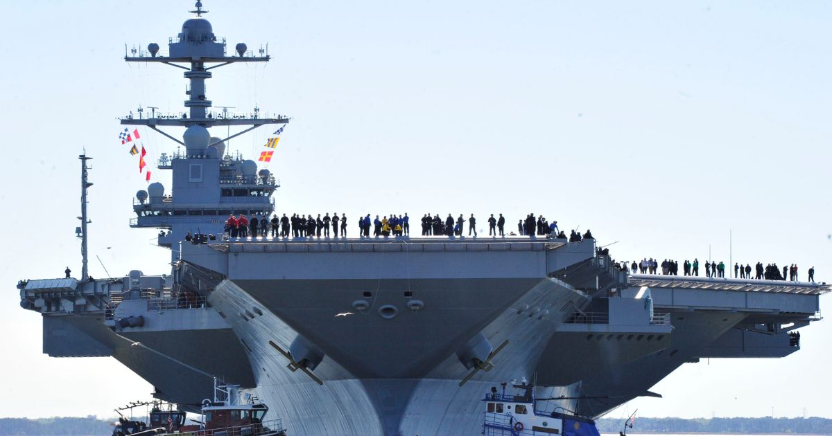 In this handout photo provided by the U.S. Navy, sailors aboard the aircraft carrier Pre-Commissioning Unit Gerald R. Ford man the rails as the ship departs Huntington Ingalls Industries Newport News Shipbuilding for builder's sea trials off the U.S. East Coast on April 8, 2017, in Newport News, Virginia.