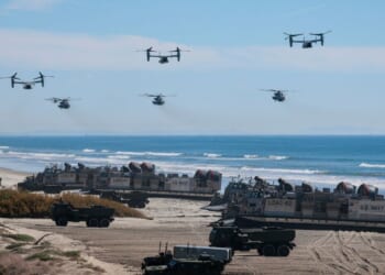 U.S. Navy Landing Craft Air Cushions unload equipment onto the beach as U.S. Marine Corps V-22 Ospreys and CH-53 Super Stallions fly overhead during the America's Marines 250 event at Camp Pendleton's Red Beach on Oct. 18, 2025, in Oceanside, California.