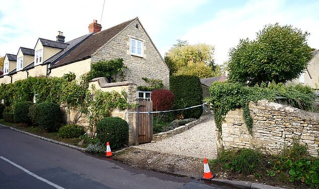 Police have launched a murder probe following the death of a girl in a picture-postcard Cotswold village. Photo shows the police cordon at the house in Islip today