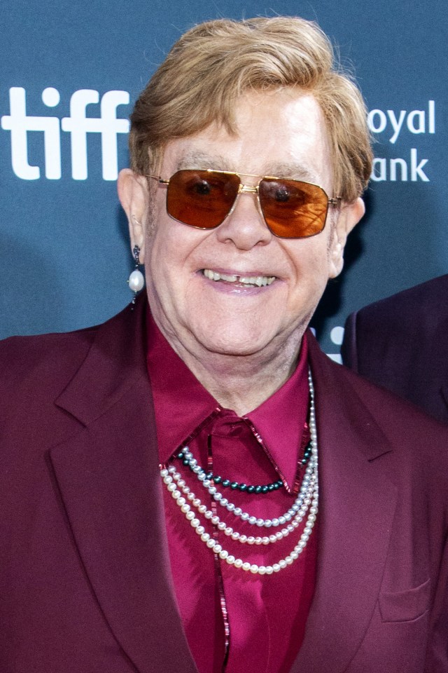 Elton John smiles while attending the premiere of "Elton John: Never Too Late."