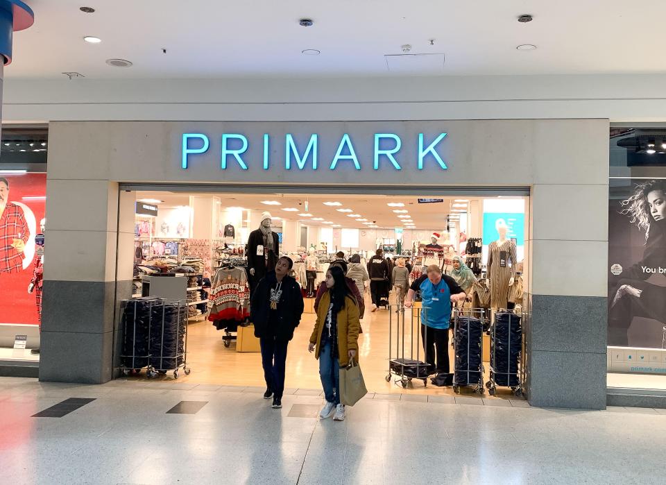 Primark store entrance with customers and staff.
