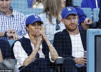 Prince Harry and Meghan Markle appeared closer than ever as they stepped out for a baseballl match in California last night