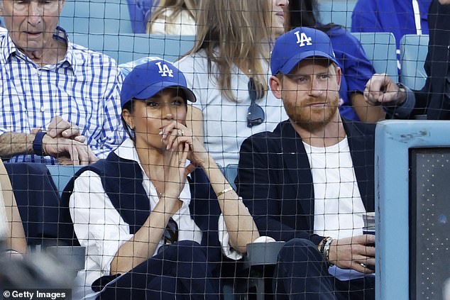 Prince Harry and Meghan Markle appeared closer than ever as they stepped out for a baseballl match in California last night