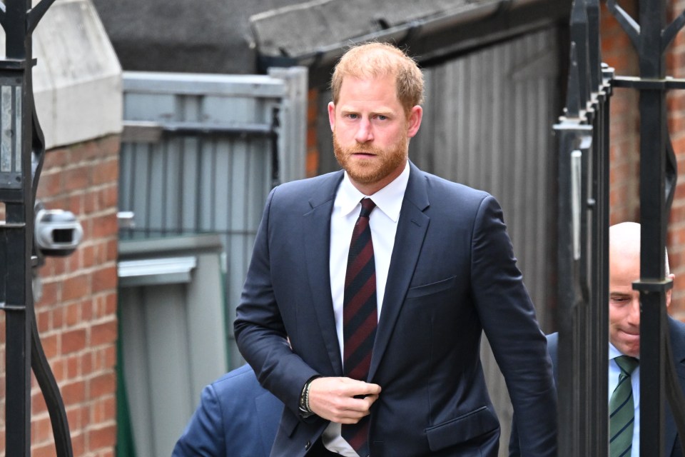 Prince Harry in a suit and tie arrives at the High Court.